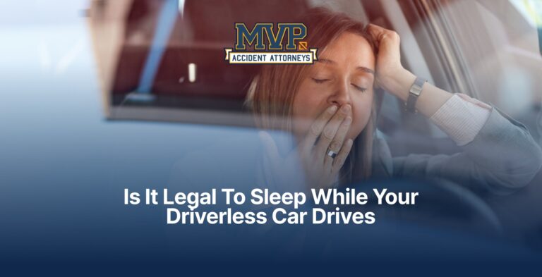 Woman yawning at the wheel of a car, with the MVP Accident Attorneys logo and the title Is It Legal To Sleep While Your Driverless Car Drives