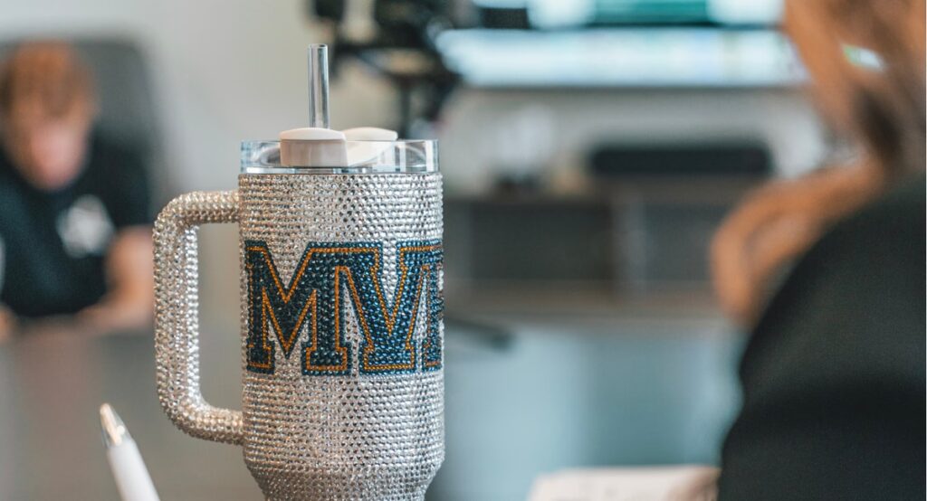 MVP branded crystal-studded tumbler with straw in office setting